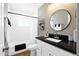 Modern bathroom featuring a shower-tub combo, white subway tile, and a stylish vanity with a round mirror at 2044 W 1St St, Mesa, AZ 85201