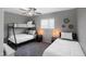 Cozy bedroom featuring a bunk bed, a single bed, and a ceiling fan at 2044 W 1St St, Mesa, AZ 85201