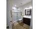 Bright bathroom featuring a glass-enclosed shower and modern vanity at 2060 E Quartz St, Mesa, AZ 85213