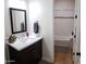 Modern bathroom with white marble countertops, a dark wood vanity, and a white tiled shower and tub at 2060 E Quartz St, Mesa, AZ 85213