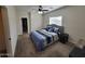 Comfortable bedroom featuring plush carpet, a ceiling fan, and ample natural light at 2060 E Quartz St, Mesa, AZ 85213
