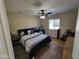 Bedroom with hardwood floors, ceiling fan, and a large window at 2060 E Quartz St, Mesa, AZ 85213