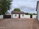 Charming exterior view of the property with a red door and well-maintained landscaping at 2060 E Quartz St, Mesa, AZ 85213