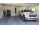 A clean and spacious garage featuring a new pickup truck at 2060 E Quartz St, Mesa, AZ 85213