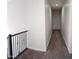 Second floor hallway with new carpet and a window allowing for plenty of light at 2060 E Quartz St, Mesa, AZ 85213