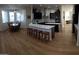 Modern kitchen with breakfast bar, dark cabinetry, white countertop, stainless steel appliances and tile backsplash at 2060 E Quartz St, Mesa, AZ 85213