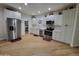 Modern kitchen with white cabinets, stainless steel appliances, and pantry at 2060 E Quartz St, Mesa, AZ 85213