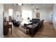 Spacious living room with wood floors, recessed lighting, ceiling fans, and comfortable leather couches and recliners at 2060 E Quartz St, Mesa, AZ 85213