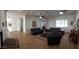 Spacious living room with wood floors, recessed lighting, and matching leather couches perfect for entertaining at 2060 E Quartz St, Mesa, AZ 85213