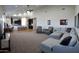 Spacious open-concept living room features sectional couch, lots of seating and an adjacent modern kitchen at 2060 E Quartz St, Mesa, AZ 85213