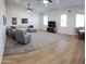 Open-concept living room with a large sectional couch, ceiling fan and lots of natural light at 2060 E Quartz St, Mesa, AZ 85213