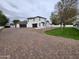 Rear exterior showcasing the paved driveway, lawn, and home at 2060 E Quartz St, Mesa, AZ 85213