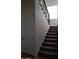 Carpeted staircase with a dark wood and iron railing leading to the second floor at 2060 E Quartz St, Mesa, AZ 85213