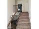 Carpeted staircase with a dark wood and iron railing leading to the downstairs living area at 2060 E Quartz St, Mesa, AZ 85213