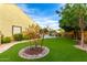 Expansive backyard with lush landscaping, artificial turf, and a putting green, perfect for outdoor activities at 21401 E Russet Rd, Queen Creek, AZ 85142