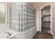 Bathroom featuring a soaking tub with glass block enclosure, and marble tiled floors at 21401 E Russet Rd, Queen Creek, AZ 85142