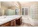 Bathroom featuring a double sink vanity, soaking tub, privacy glass block and tiled floors at 21401 E Russet Rd, Queen Creek, AZ 85142