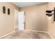 Neutral bedroom with carpet flooring, hat rack and white door with access to closet at 21401 E Russet Rd, Queen Creek, AZ 85142