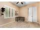 A bedroom with carpet, window with shutters, desk, fan and closet with sliding doors at 21401 E Russet Rd, Queen Creek, AZ 85142