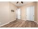 Neutral bedroom featuring wood-look flooring and a closet with sliding doors at 21401 E Russet Rd, Queen Creek, AZ 85142