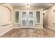 Elegant foyer with decorative front doors, tiled floors and transom windows at 21401 E Russet Rd, Queen Creek, AZ 85142