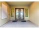 Covered entryway with decorative double doors and side windows at 21401 E Russet Rd, Queen Creek, AZ 85142