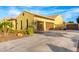 Spacious two-car garage with a wide driveway and desert landscaping at 21401 E Russet Rd, Queen Creek, AZ 85142