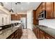 Modern kitchen with stainless steel appliances, granite counters, and ample cabinet space at 21401 E Russet Rd, Queen Creek, AZ 85142