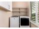 Laundry room featuring side by side washer and dryer and storage at 21401 E Russet Rd, Queen Creek, AZ 85142