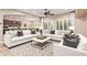 Bright living room featuring modern decor, a ceiling fan, and natural light through shuttered windows at 21401 E Russet Rd, Queen Creek, AZ 85142