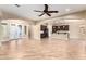 Open-concept living room flows into the kitchen, featuring neutral walls, arched doorways, and tile floors at 21401 E Russet Rd, Queen Creek, AZ 85142