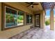 Covered patio overlooking pool with travertine pavers at 21401 E Russet Rd, Queen Creek, AZ 85142