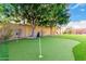 Backyard with putting green surrounded by mature trees at 21401 E Russet Rd, Queen Creek, AZ 85142