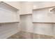 Walk-in closet with carpet flooring, white walls, and wooden shelves with wooden clothes rods at 21401 E Russet Rd, Queen Creek, AZ 85142