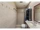 Bathroom featuring a walk in shower with decorative tile, built in shelves, and sink with wood cabinets at 2201 W Wethersfield Rd, Phoenix, AZ 85029