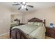This is a primary bedroom with a ceiling fan, decorative bedding, and a closet with mirrored doors at 2201 W Wethersfield Rd, Phoenix, AZ 85029