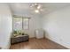 Bedroom featuring a ceiling fan, window with blinds, and ottoman with plants on top of it at 2201 W Wethersfield Rd, Phoenix, AZ 85029
