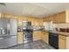 Well-equipped kitchen features stainless steel appliances, maple cabinets, and a backsplash tile design at 2201 W Wethersfield Rd, Phoenix, AZ 85029