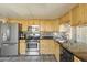 Well-equipped kitchen features stainless steel appliances, maple cabinets, and a backsplash tile design at 2201 W Wethersfield Rd, Phoenix, AZ 85029
