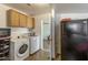 Laundry room featuring cabinets, a washer and dryer, and access to the rear yard at 2201 W Wethersfield Rd, Phoenix, AZ 85029