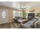 Cozy living room featuring plush seating, a ceiling fan, and natural light streaming through the window at 2201 W Wethersfield Rd, Phoenix, AZ 85029