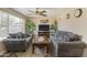 Cozy living room featuring plush seating, a ceiling fan, and natural light streaming through the window at 2201 W Wethersfield Rd, Phoenix, AZ 85029