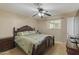 Comfortable main bedroom features a ceiling fan, natural light, and classic wood bedroom furniture at 2201 W Wethersfield Rd, Phoenix, AZ 85029