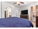 Bright bedroom featuring a ceiling fan, TV, dresser, and access to the backyard at 2641 E Binner Dr, Chandler, AZ 85225