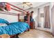 Bedroom features a four-poster bed, dresser with TV, and wood-look flooring at 2641 E Binner Dr, Chandler, AZ 85225