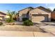 Charming single-story home with a neutral-toned stucco exterior, low maintenance landscaping, and a two-car garage at 2641 E Binner Dr, Chandler, AZ 85225