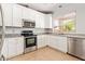 Bright kitchen with granite countertops, stainless steel appliances, and white cabinetry under recessed lighting fixtures at 2641 E Binner Dr, Chandler, AZ 85225