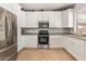 Well-lit kitchen featuring granite countertops, stainless steel appliances, and white cabinets with ample storage at 2641 E Binner Dr, Chandler, AZ 85225
