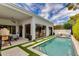 Luxury backyard features a pool, patio, artificial turf, and large sliding doors to home at 2737 E Arizona Biltmore Cir # 8, Phoenix, AZ 85016