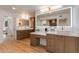 Bright bathroom with double vanities, recessed lighting, and large lighted mirrors at 2737 E Arizona Biltmore Cir # 8, Phoenix, AZ 85016